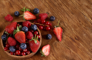 Poster - fresh berries raspberries strawberries currants on a wooden table