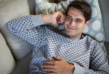 Poster - Smile, phone call and top view of man in home on sofa for conversation, chat or listening to contact. Smartphone, above and happy person on couch for communication, news or relax to talk on mobile
