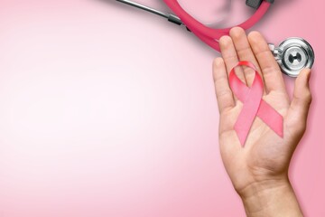 Wall Mural - Breast Cancer Month with hand holding ribbon