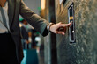 © Drazen - Close up of businesswoman pressing elevator button in hotel lobby.