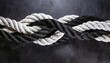 strong black and white rope knot on a dark background and unity concept - elimination of color discrimination