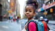 © Sunny - Cute girl, a junior school student, stands with a backpack on her back on the street looking at camera getting ready to go to school. Concept of back to school, learning, school times, banner