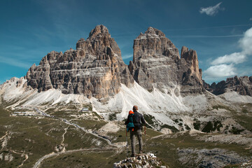 Wall Mural - Stunning view of a tourist enjoying the view of the Tre Cime Di Lavaredo, Dolomites, Italy.