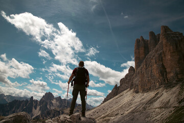 Wall Mural - Stunning view of a tourist enjoying the view of the Tre Cime Di Lavaredo, Dolomites, Italy.