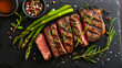 sliced beef grill steak with green asparagus, dark background