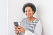 © Louis-Paul Photo - senior woman using her cellphone on white room