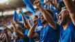 © Marco - Group of people with blue shirts cheering on their soccer team with blue flags in the stadium in high resolution and high quality. football, sports concept