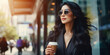 © OleksandrZastrozhnov - A stylish female office worker in a business suit walks down the street with a cup of coffee.