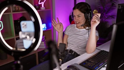 Canvas Print - Beautiful brunette, with blue eyes, astonished and afraid while recording bitcoin video in dark gaming room, an expression of shock, excitement, and disbelief!