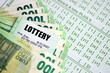 © mehaniq41 - Green lottery tickets and euro money bills on blank with numbers for playing lottery close up