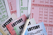 © mehaniq41 - Lottery tickets of different colors and pen on blank bills with numbers for playing lottery close up