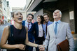 © Marko Geber - Diverse business people laughing while walking to work