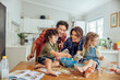 © Marko Geber - Happy family baking together in the kitchen