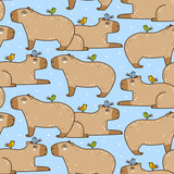Fototapeta Na ścianę - Seamless pattern with cute сartoon capybaras and birds on blue - funny animal background for Your textile and wrapping paper design