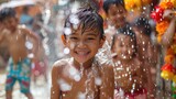 Fototapeta  - Songkran, Children in high spirits, captured in a moment of pure joy and laughter, as they play in glistening water sprinkles on a sunny day.