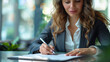 © JMarques - Happy business woman signing a new employment contract. Employee signing documents with a pen in the office. Concept of signing, documents, human resources,
