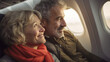 © dvoevnore - Joyful senior couple travelling by plane, holiday vacation concept