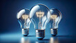 Three glowing light bulbs radiates brilliance against a serene blue background