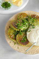 Wall Mural - Vegetable pancakes with spinach and greens. on a beige plate