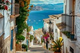 Fototapeta Fototapeta uliczki - A picturesque view of Altea old town, characterized by its narrow winding streets and charming whitewashed houses nestled against the backdrop of the Mediterranean sea in Alicante province