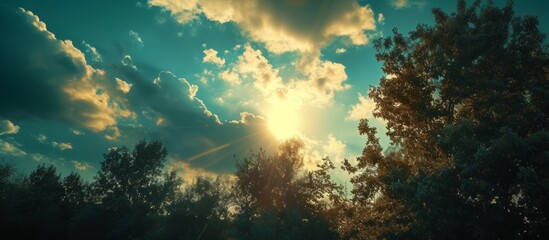 Wall Mural - Glorious sun shining through fluffy white clouds in a serene blue sky background