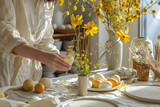 Fototapeta Na drzwi - Happy Easter! Woman preparing table with Easter spring flowers for holiday. Light background.