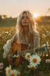 a blonde woman playing guitar at sunset