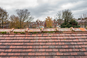 Aerial photo of a typical British terrace house in the UK showing the roof and tiles on the dirty roof on the house in the winter time