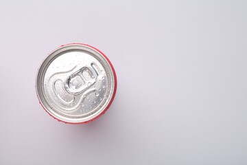 Canvas Print - Energy drink in wet can on light grey background, top view. Space for text