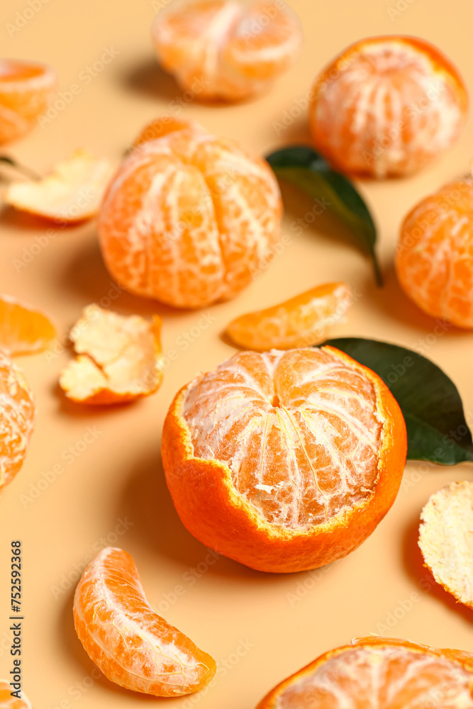 Sweet tangerines with leaves on beige background