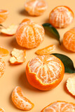 Fototapeta Na sufit - Sweet tangerines with leaves on beige background