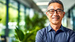 Smiling adult Asian man executive promoting eco-friendly business values. Concept of harmony corporate success and sustainable environmental practices on a green office background. Copy space, banner