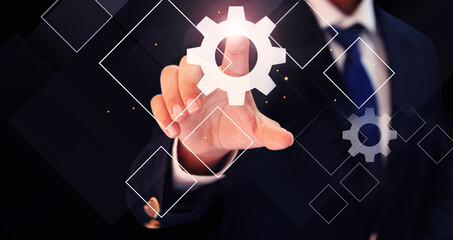 Poster - Man Touching Setting Icon on Screen Futuristic concept background. Person touching on dark backdrop with glowing lens flare light