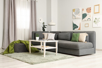 Sticker - Stylish interior of living room with cozy sofa and coffee table