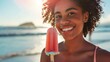 Beautiful brunette woman with curls eating a popsicle on a sunny beach in summer with the sea in the background in high definition and high quality. ice cream concept