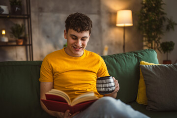 Young man caucasian teenager read book study at home education concept