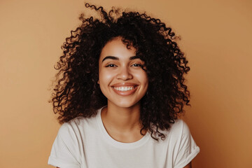 Portrait of a cheerful smiling young brunette with afro hair on pastel background. Generative AI.