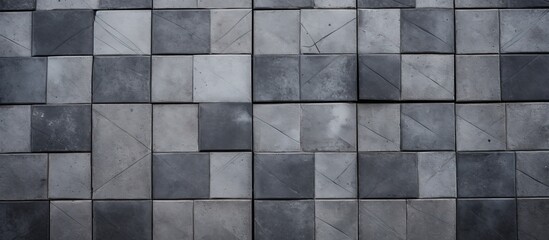 Poster - A black and white image showcasing a tiled wall, with grey concrete tiles perfectly arranged in a geometric pattern. The contrast between the dark and light tiles creates a visually striking design.