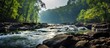 A river meanders through a dense, vibrant green forest, creating a picturesque scene of natural beauty. The lush vegetation envelops the winding waterway, showcasing the harmony of flowing water and