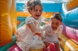 Children jumping on a bouncy castle celebrating their communion with laughter and fun