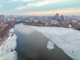 The spring river in the city is melting from ice. The ice on the river began to melt. Yekaterinburg, Russia