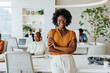 © (JLco) Julia Amaral - Confident black woman with afro hair smiling in a startup office