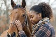 Tender moment between a plus-size African American woman and a horse in an autumn setting.