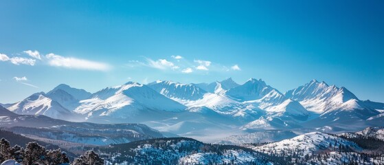 Wall Mural - panoramic view of pristine snow-covered mountain peaks under blue sky