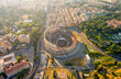 © nikitamaykov - Rome, Italy. Colosseum - A monumental three-level Roman amphitheater where gladiator fights took place. Panorama of the city on a summer morning. Aerial view