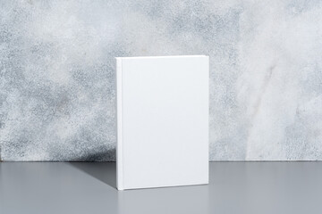 Poster - White blank book with hard cover on gray background with shadows