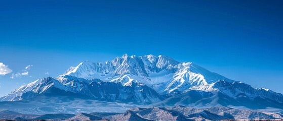 Wall Mural - panoramic view of pristine snow-covered mountain peaks under blue sky