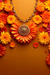 Vivid marigold flower garland on a yellow background. Holi abstract greeting card witj copy space