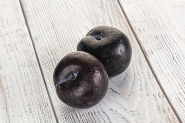 Two ripe sweet black plums