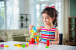 © StockImageFactory - Indian asian child preschooler girl playing wooden toys at home or kindergarten